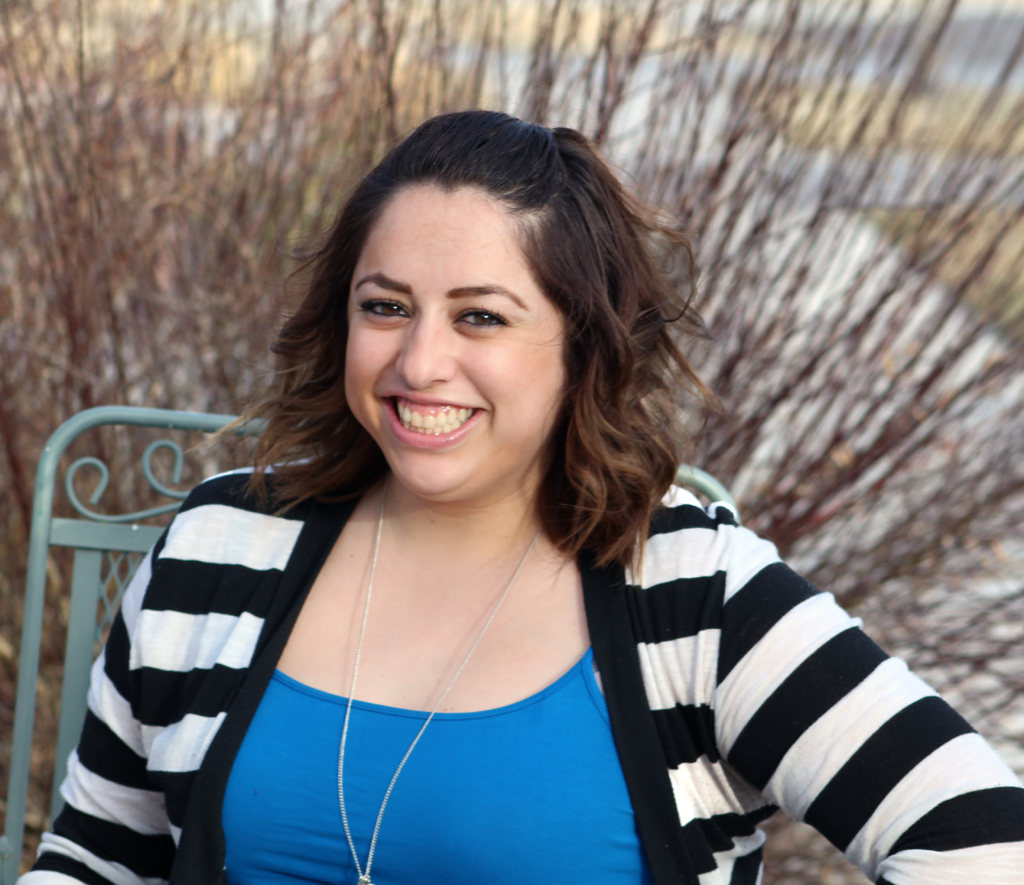 headshot of Natalie Villa; a hispanic woman with curly hair.