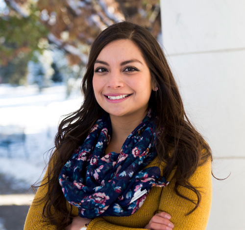 headshot of Samantha Ortega. A hispanic woman standing outside with long brown hair.