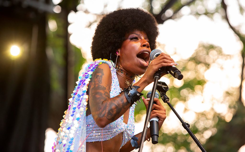A woman on stage singing her heart out.