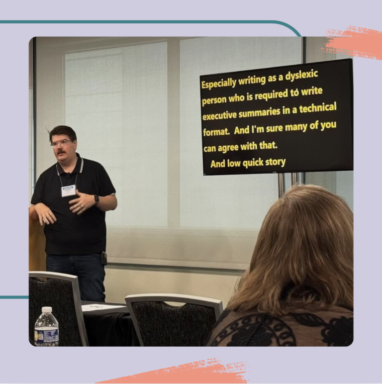 A presenter speaks at a conference, gesturing with hands, while a screen behind displays text about writing as a dyslexic person. The audience is partially visible.